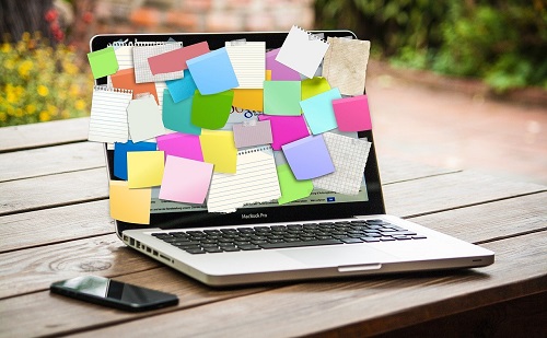 laptop covered in post-it notes