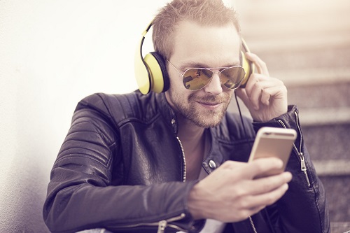 man listening to podcast with headphones